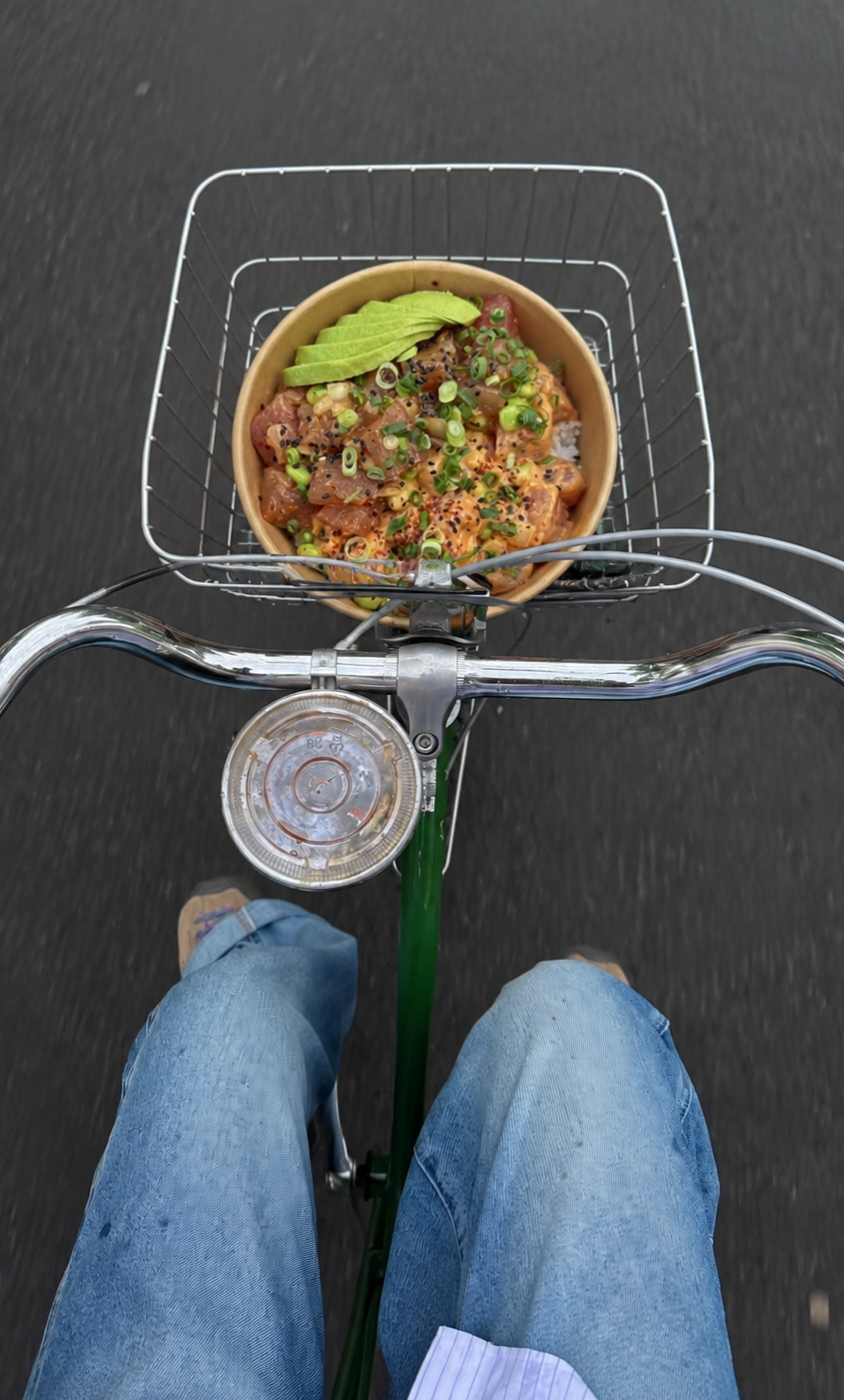 Poké bowl riding in a bicycle basket